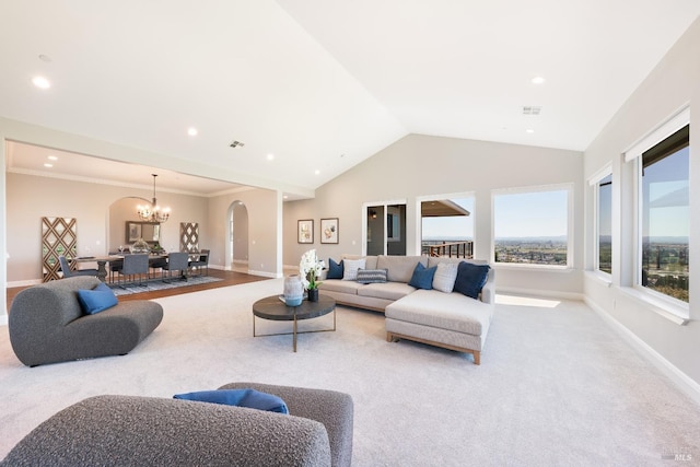 carpeted living room with ornamental molding, vaulted ceiling, and a notable chandelier