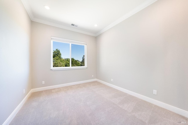 carpeted spare room featuring ornamental molding