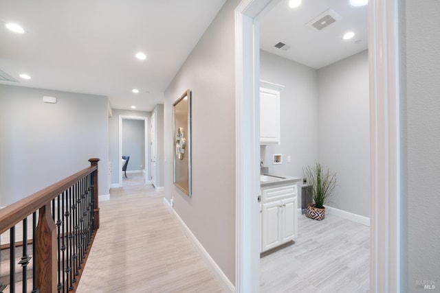 hall featuring sink and light hardwood / wood-style flooring