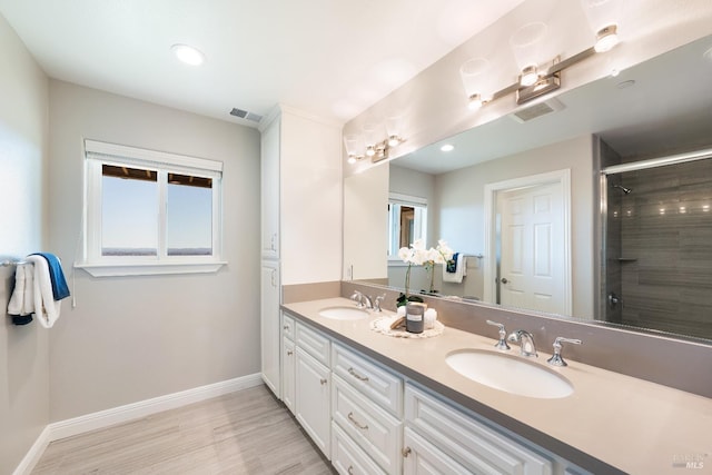 bathroom with vanity, wood-type flooring, and a shower with shower door