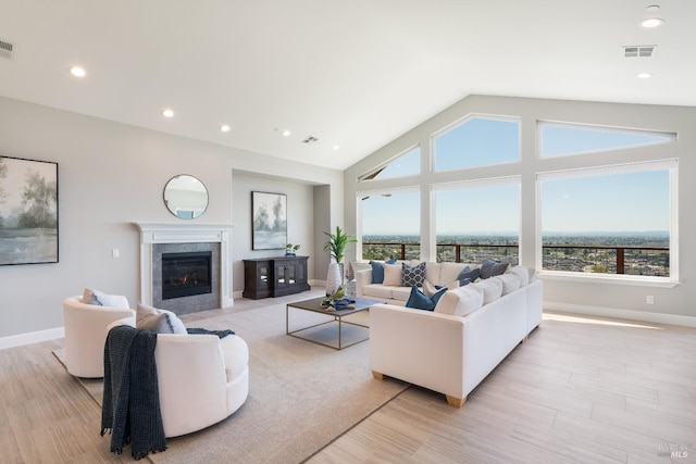 living room with light hardwood / wood-style flooring and lofted ceiling