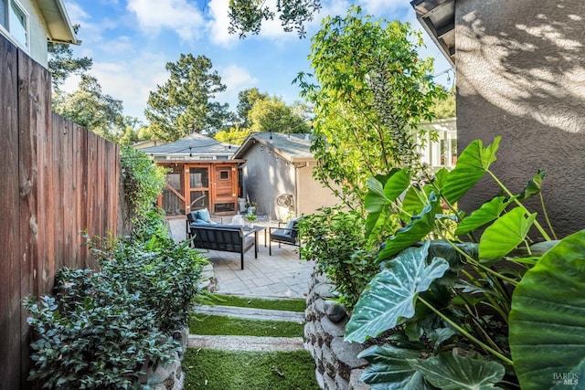 view of yard with an outdoor living space, a patio area, and an outdoor structure