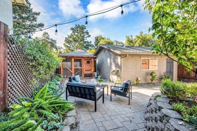 view of patio / terrace featuring an outdoor living space and an outbuilding