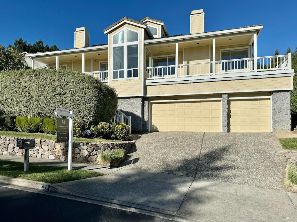 view of front of home featuring a balcony and a garage