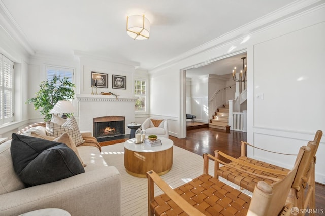 living room with a chandelier, crown molding, and dark hardwood / wood-style floors