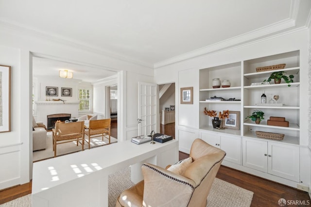 office area featuring built in shelves, dark hardwood / wood-style floors, and crown molding