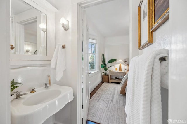 bathroom with sink and lofted ceiling