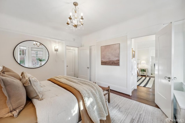 bedroom featuring a notable chandelier and hardwood / wood-style floors