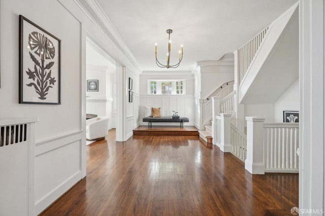 interior space with crown molding, a notable chandelier, and dark hardwood / wood-style flooring