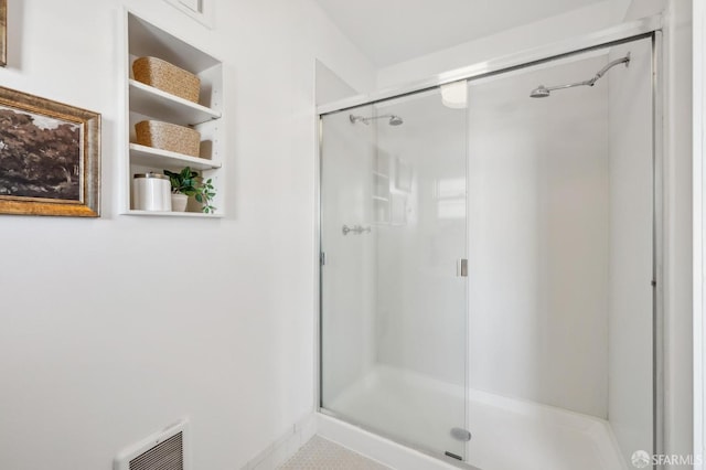 bathroom featuring a shower with shower door