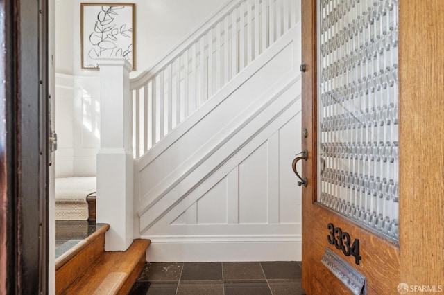 stairs with tile patterned floors