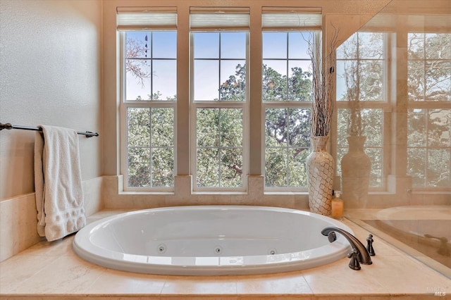 bathroom with a relaxing tiled tub