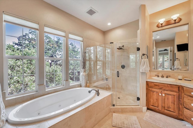 bathroom featuring shower with separate bathtub, tile patterned floors, and vanity