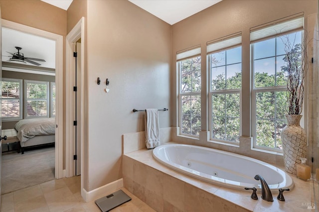 bathroom featuring tiled bath, ceiling fan, tile patterned floors, and plenty of natural light