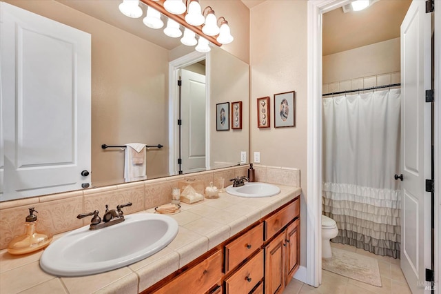 bathroom with toilet, tile patterned floors, backsplash, and vanity