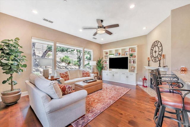 living room featuring ceiling fan and hardwood / wood-style flooring