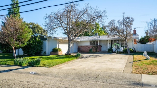 ranch-style house with a garage and a front yard