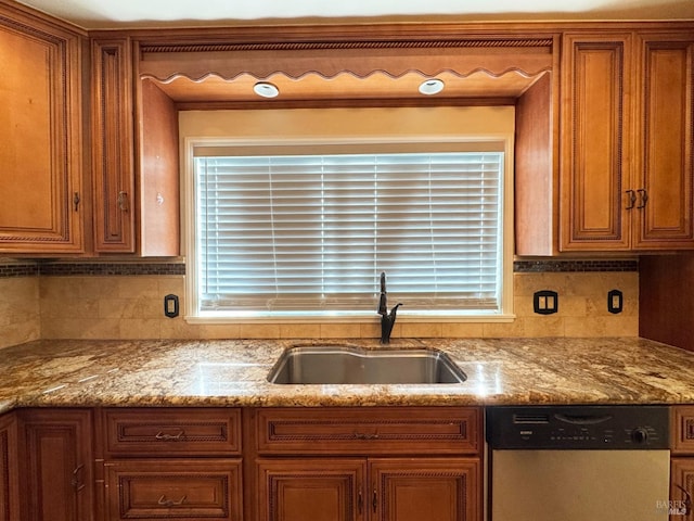 kitchen with backsplash, dishwasher, plenty of natural light, and sink