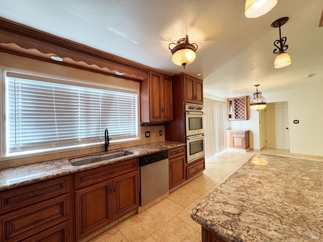 kitchen featuring sink, a healthy amount of sunlight, pendant lighting, light tile patterned floors, and appliances with stainless steel finishes