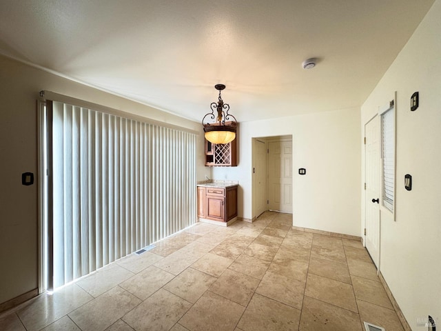 unfurnished living room with indoor bar