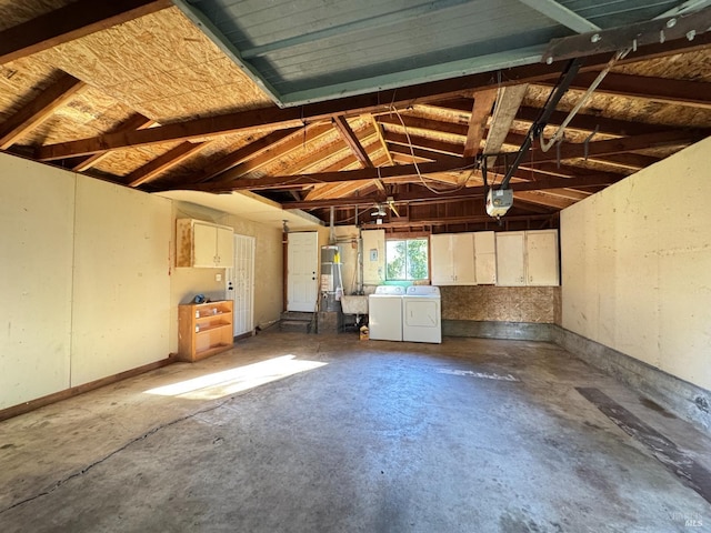 garage with separate washer and dryer and a garage door opener