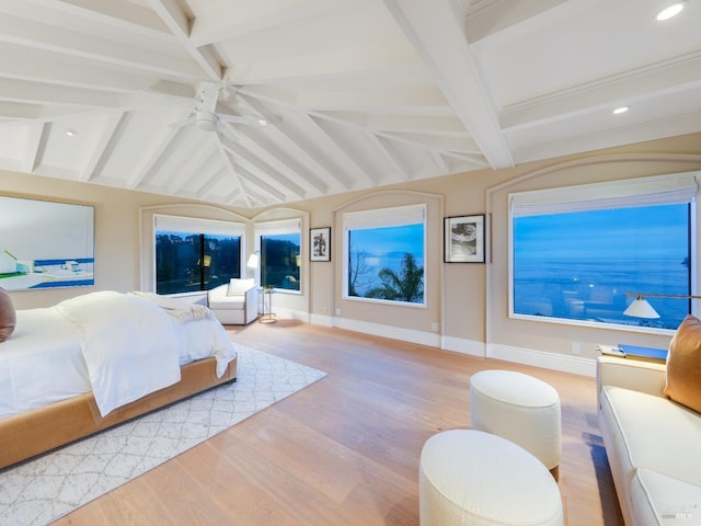 bedroom featuring vaulted ceiling with beams, ceiling fan, and light hardwood / wood-style flooring