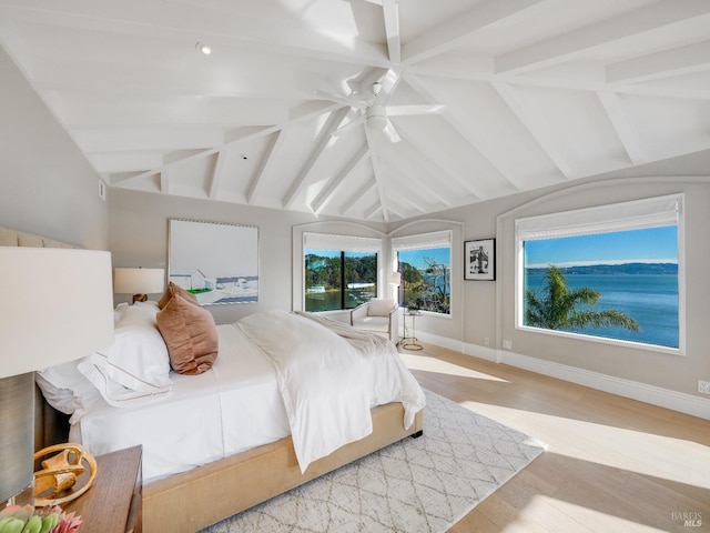 bedroom featuring light hardwood / wood-style floors, vaulted ceiling, and ceiling fan