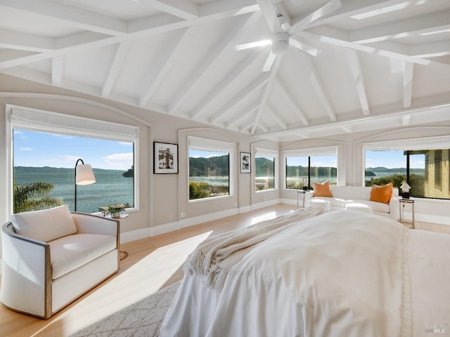 bedroom featuring multiple windows, ceiling fan, a water view, and light hardwood / wood-style floors