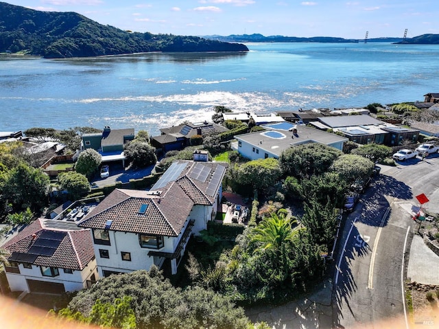 drone / aerial view featuring a water and mountain view