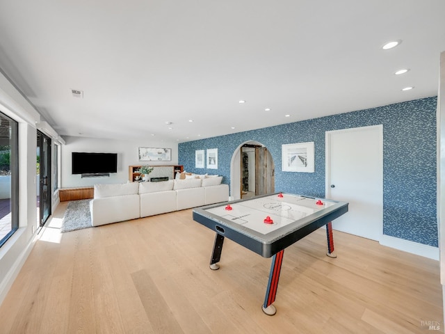 game room with light hardwood / wood-style flooring