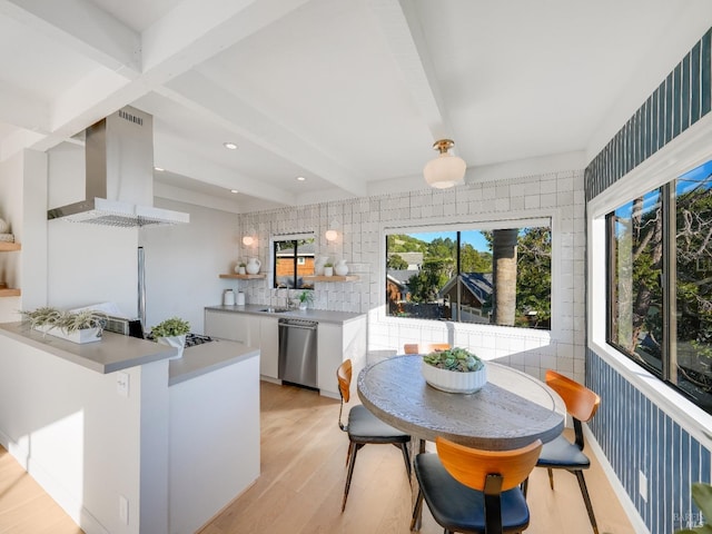 interior space featuring beam ceiling, light hardwood / wood-style floors, and sink