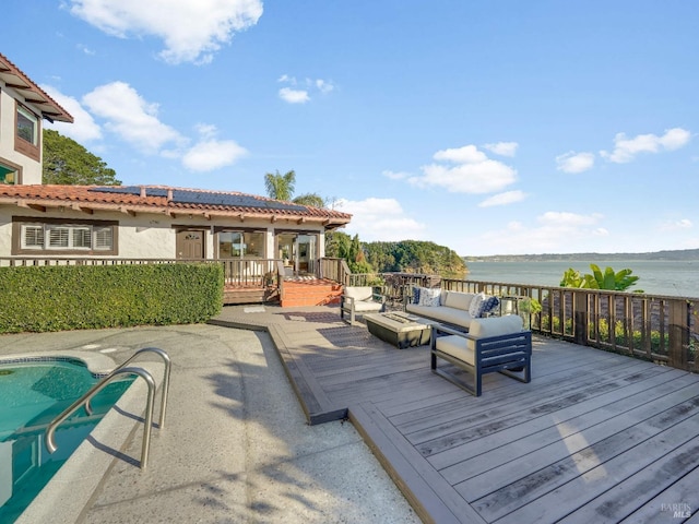 wooden terrace with outdoor lounge area and a water view