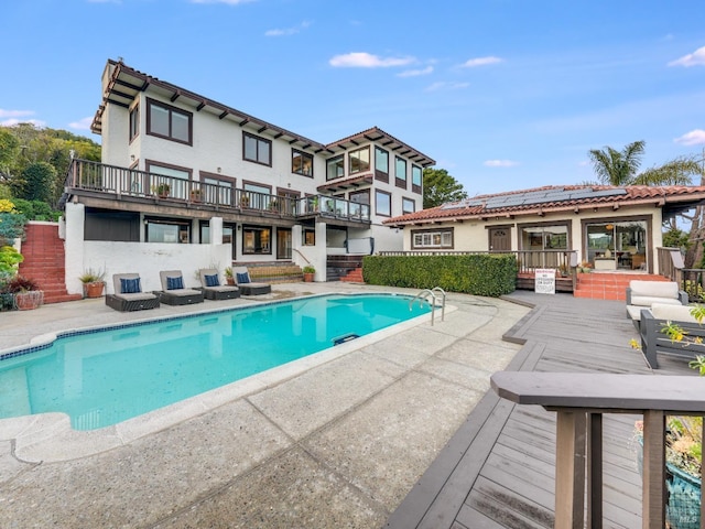 view of swimming pool with a deck