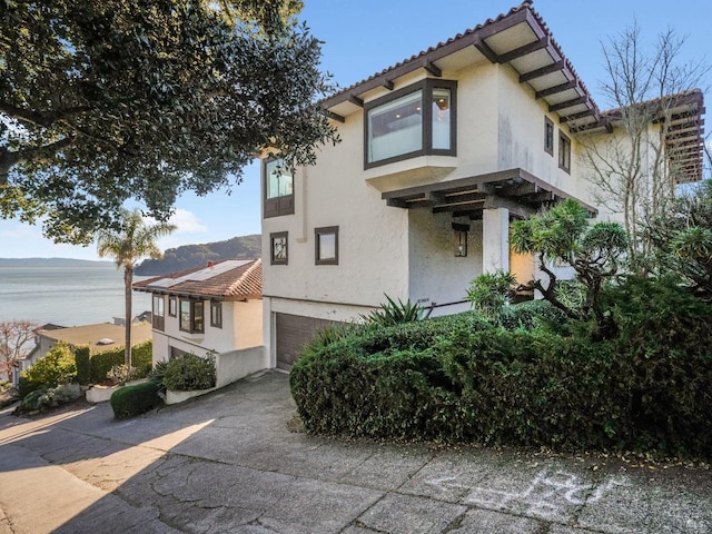 view of front of home featuring a garage and a water view