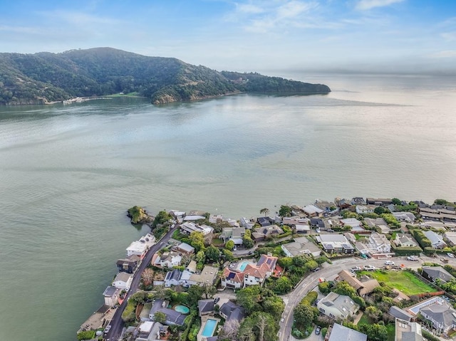 drone / aerial view featuring a water and mountain view