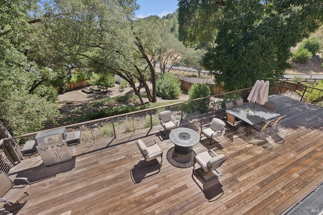 wooden terrace featuring an outdoor fire pit