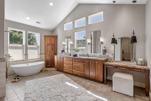 bathroom featuring a washtub, vanity, tile patterned flooring, and high vaulted ceiling