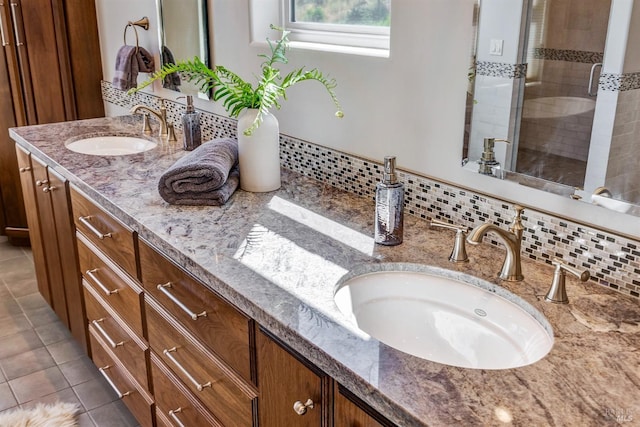 bathroom with tasteful backsplash, vanity, tile patterned floors, and a shower with shower door