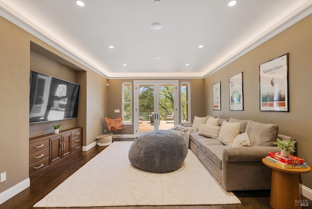 living room with dark hardwood / wood-style flooring, crown molding, and french doors