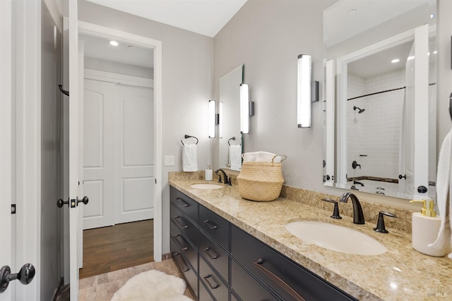 bathroom with vanity and tiled shower / bath combo