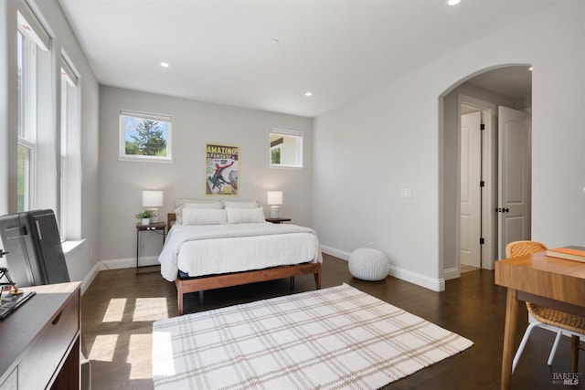 bedroom with dark hardwood / wood-style floors