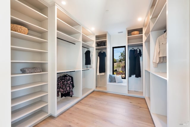 spacious closet featuring light hardwood / wood-style flooring