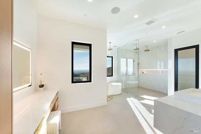 bathroom with vanity and separate shower and tub