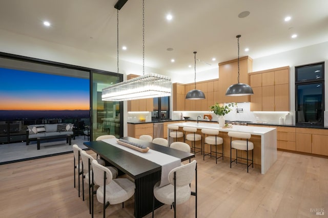 dining space with light hardwood / wood-style flooring