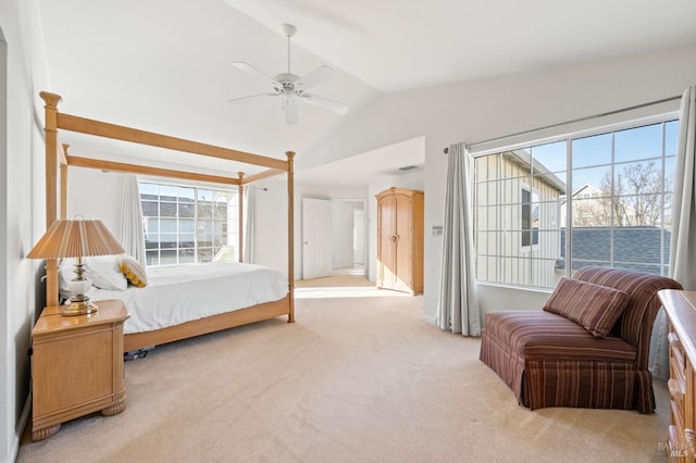 carpeted bedroom featuring ceiling fan, multiple windows, and lofted ceiling