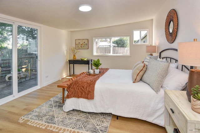 bedroom with light wood-type flooring and access to exterior