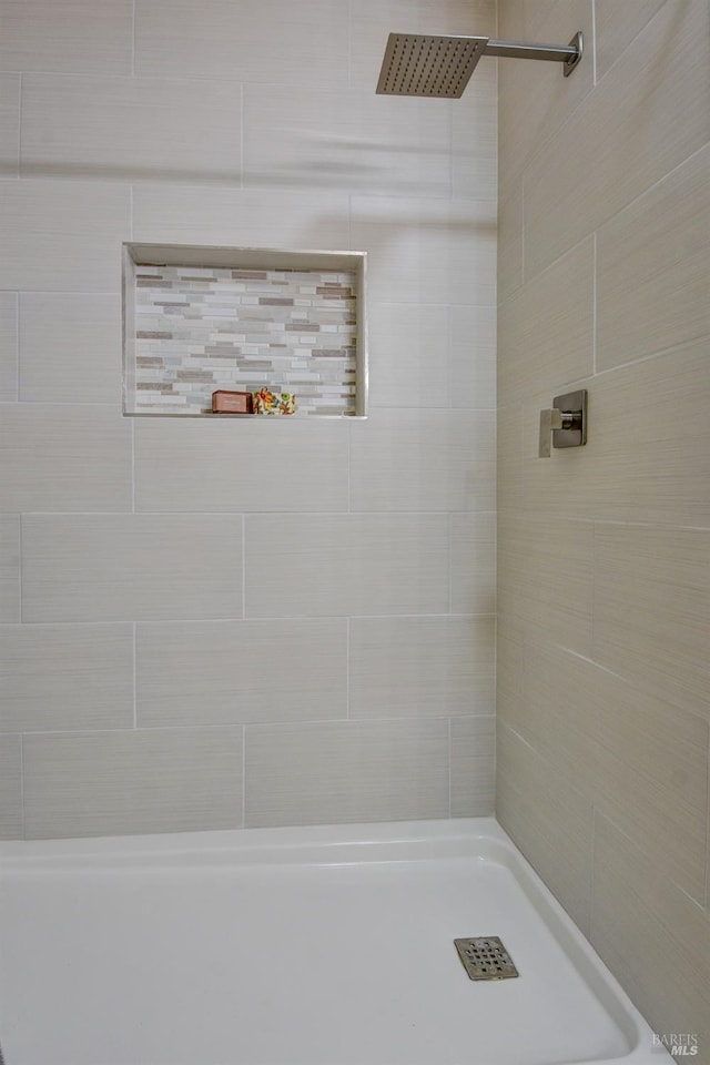 bathroom with a tile shower