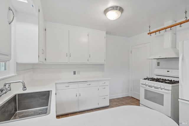 kitchen featuring white appliances, white cabinetry, and sink