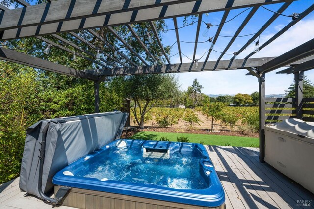 view of pool featuring a covered hot tub, a pergola, and a deck