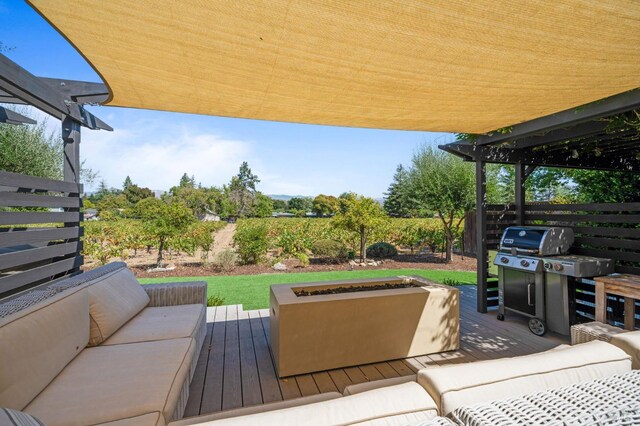 wooden deck with an outdoor living space and fence